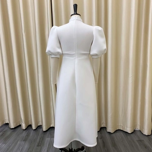 Detailed back view of white evening dress with puff sleeves and invisible zipper closure