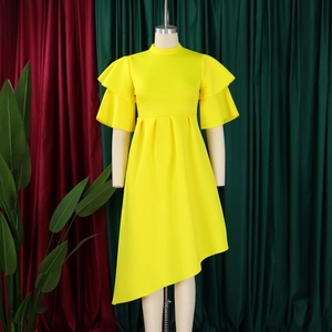 Detail of a bright yellow dress with double-layered ruffle sleeves and irregular hem