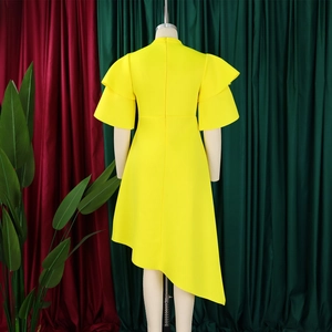 Detail of a bright yellow dress featuring double-layered ruffle sleeves and asymmetric hem