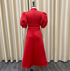 Detail of red bubble sleeve dress with high collar and invisible back zipper closure