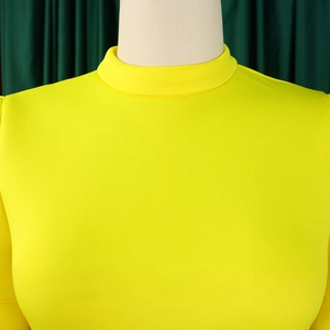 Detail of bright yellow high neck dress with ruffled sleeves on a mannequin display