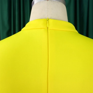 Detail view of the yellow dress back with a seamless hidden zipper and neat stitching