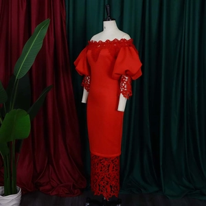 Detail of red off-shoulder gown featuring puff sleeves and intricate floral lace trim