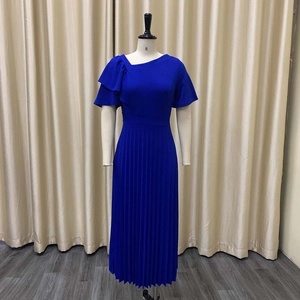Detail of royal blue pleated dress featuring asymmetric neckline and ruffle sleeves