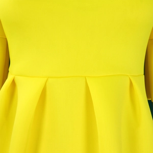Close-up of bright yellow waist design and vertical pleats on a summer maxi dress