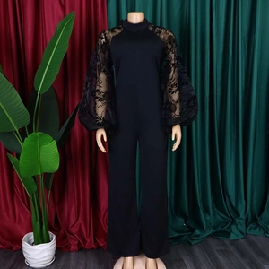 Detail of elegant black jumpsuit featuring floral lace mesh puff sleeves and high waist