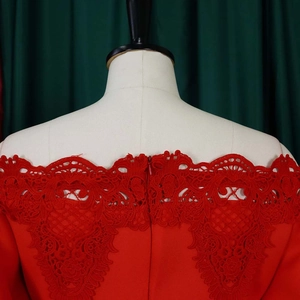 Close-up of the red lace off-shoulder neckline and back invisible zipper detail
