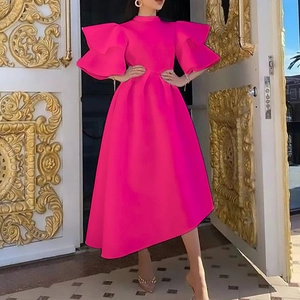 Detail view of the layered ruffle sleeves and elegant waistline of the magenta dress