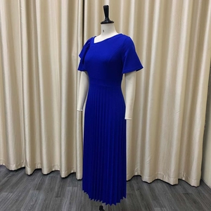 Detailed side view of pleated maxi dress hem with elegant high waistline and ruffled sleeves