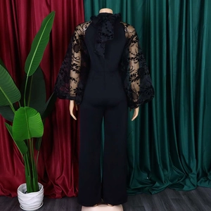 Elegant black wide-leg jumpsuit with mesh lace puff sleeves and a back bow-tie high neck