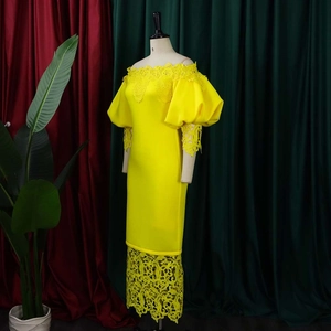 Close-up of bright yellow off-shoulder dress with 3D floral lace and puff sleeves