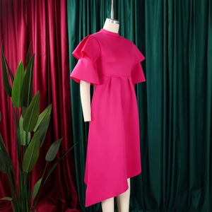 Detail of hot pink dress with double layer ruffle sleeves and asymmetric hemline