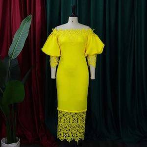 Detail of yellow off-shoulder dress featuring intricate lace lantern sleeves and hem