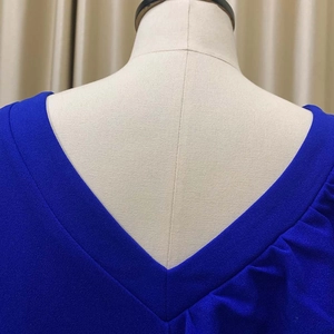 Detail of royal blue V-neckline with pleated texture and high-quality stitching