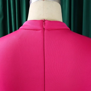 Detail of rose red dress featuring an invisible zipper and fine knit texture on the back