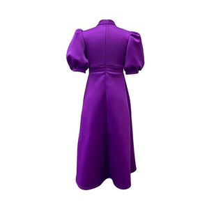 Detail view of the back of a purple A-line dress with bubble sleeves and a hidden zipper
