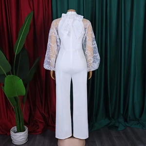Elegant white jumpsuit featuring sheer floral embroidered puff sleeves and a back bow tie