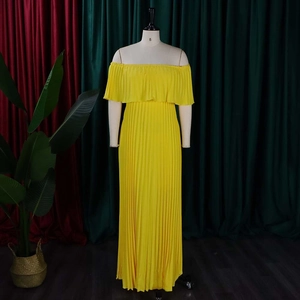 Détail d'une robe longue plissée à épaules dénudées en jaune vif avec bustier smocké