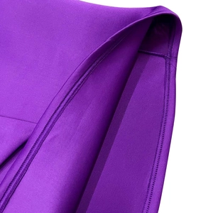 Macro shot of double-stitched hem and smooth fabric texture on purple formal dress