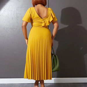 Detail of ginger yellow pleated midi dress with ruffle sleeve and elegant V-back design