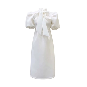 Detail of elegant white dress featuring large bow knot and puff sleeves on high collar
