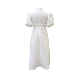 Detail view of the back of a white puff sleeve dress featuring a discreet hidden zipper