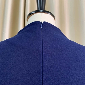 Détail de l'encolure dos avec fermeture éclair invisible sur une robe bleu marine