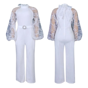 Detail of white jumpsuit featuring floral lace balloon sleeves and belted waist design