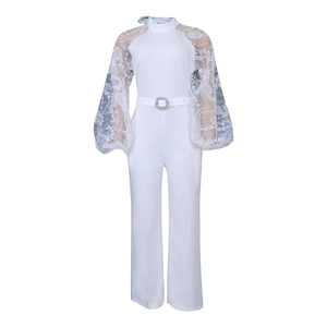 Detailed view of white jumpsuit with lace puff sleeves and crystal-buckle belt accessory