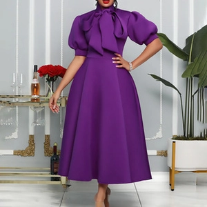 Detail of purple dress featuring oversized bow neckline and elegant puff sleeves