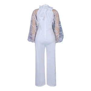 Detailed back view of white jumpsuit with lace lantern sleeves and a large lace bow