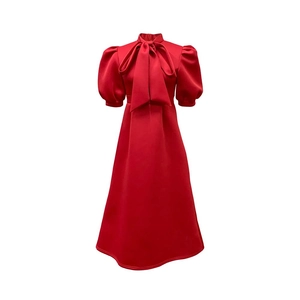Detail view of red party dress with elegant bow collar and vintage puff sleeves