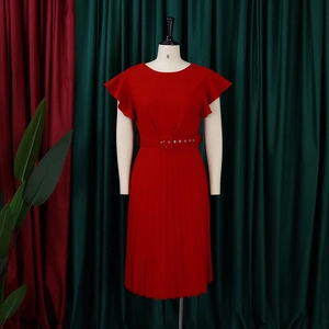 Detail view of red pleated dress with ruffle sleeves and matching square buckle belt