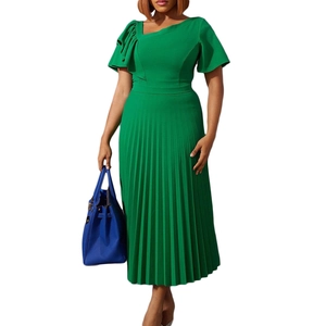 Detail of green ruffle short sleeve dress with asymmetric neckline and pleated skirt