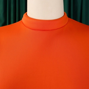 Detail of high collar orange dress with double ruffle sleeves and neat stitching