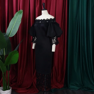 Detail of off-shoulder lace neckline and puff sleeves on this elegant black evening gown
