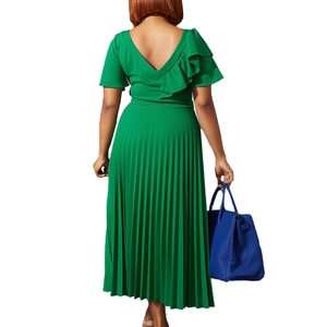 Detail view of the green pleated dress back showing V-neck cutout and ruffle sleeve
