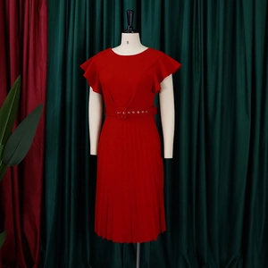Detail of red pleated midi dress with ruffle sleeves and matching buckle waist belt