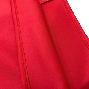 Detailed close-up showing precision stitching and fabric texture of red party dress