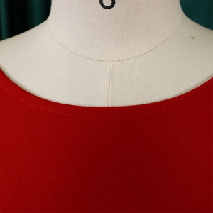 Close-up of a red round neckline with detailed double-needle flat seam stitching on fabric