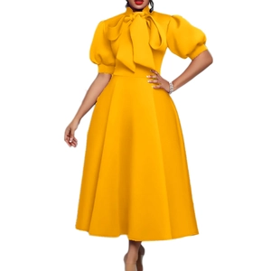 Detailed view of yellow elegant midi dress with large bow-knot collar and puff sleeves