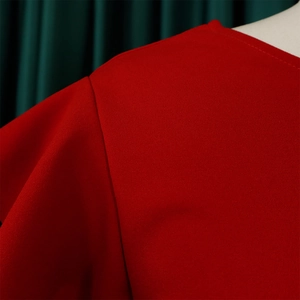Detail of red round neck stitching and fine needlework on summer pleated dress