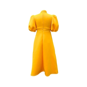 Detail of elegant yellow high-neck dress back view with puff sleeves and A-line silhouette