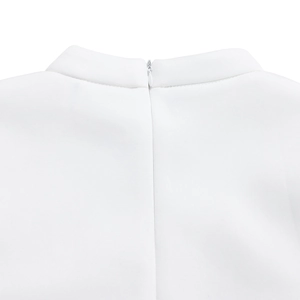 Close-up of white dress showing standing collar and invisible back zipper detail