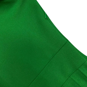 Detail view of emerald green dress with hidden side zipper and premium fabric texture