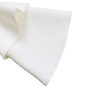 Detailed view of the layered ruffle sleeve stitching and white woven fabric texture