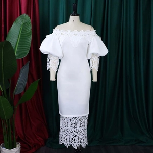 Detail of elegant off-shoulder white lace dress featuring lantern sleeves and floral applique