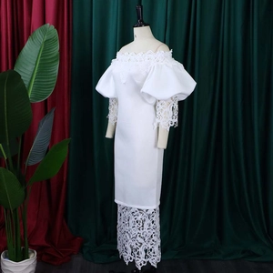 Detail of white off-shoulder dress featuring intricate floral lace on sleeves and hemline