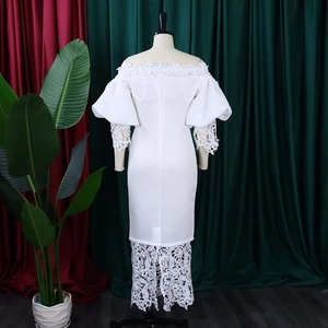 Detail of white off-shoulder lace dress with lantern sleeves and floral lace stitching