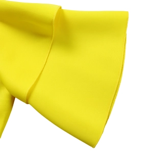 Detail of bright yellow double-layer ruffle sleeves with professional overlock stitching